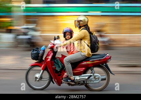 Cambodian People Travelling by Motorcycle, Siem Reap, Siem Reap Province, Cambodia. Stock Photo