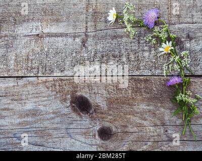 Beautiful wildflowers lying on a wooden table Stock Photo