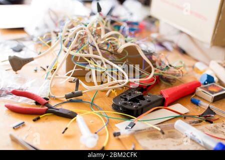 Different electrical wires and other tools on the desktop for working with electronics Stock Photo
