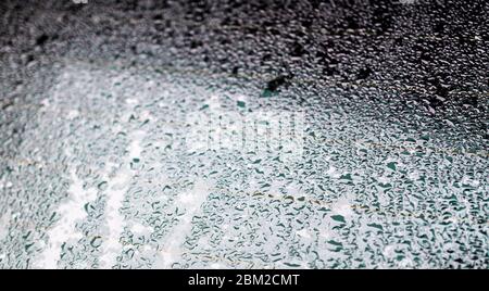 rain drops on a back window of a car Stock Photo