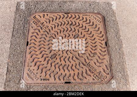 Bristol-May-2020-England- a close up view of the metal drain cover on top of the underground water drain under the main street Stock Photo