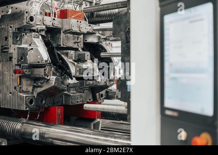 Huge injection molding machine without fixture ready for the plastic articles by injecting heated material into mold Stock Photo