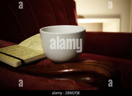 Relaxing coffee and book in arm chair Stock Photo