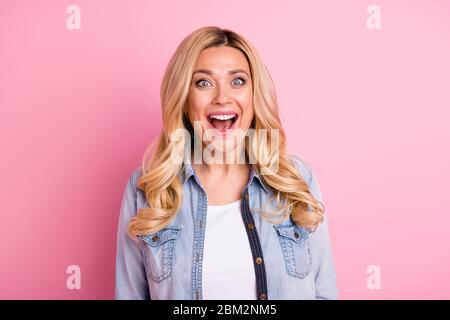 Portrait of astonished cheerful mature woman hear wonderful spring time bargain impressed scream wear stylish clothes isolated over pastel color Stock Photo