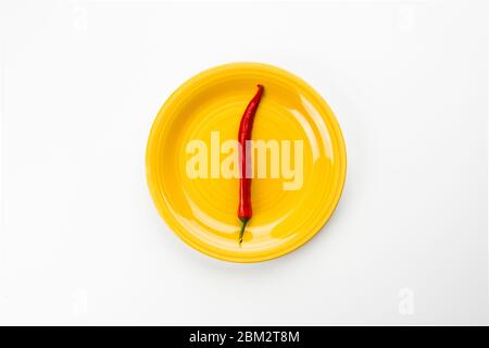 Yellow plate with red Chili pepper. Stock Photo