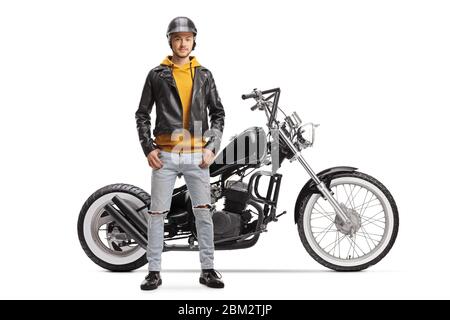 Full length portrait of a young man biker in a leather jacket posing next to his motorbike isolated on white background Stock Photo