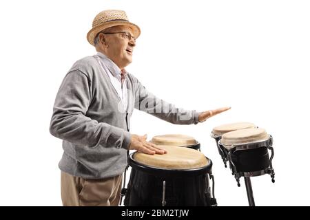 Elderly man playing conga drums isolated on white background Stock Photo