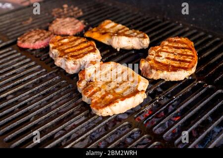 Entrecote Beef Steak On Grill With Rosemary Pepper And Salt - Barbecue.Grilled beef fillet steaks with herbs and spices.Beef steak on the grill grate Stock Photo