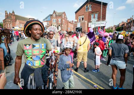 Street scene with man in rasta hat at the Chapeltown - Leeds West Indian Carnival Stock Photo