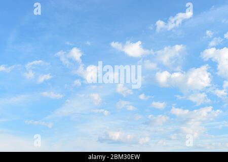 A lot of small fluffy clouds floatind high in a blue spring or summer sky on a sunny day. Meteorology, weather and different cloud types. Stock Photo