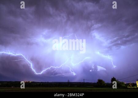 Lightning bolts  illuminate the stormy sky over Monteton, Lot-et-Garonne, France Stock Photo