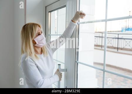 A woman standing in front of a door Stock Photo