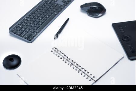 Modern working desk with keyboard, pen, mouse and graphic designer table. Creative person working in advertising from home with copy space Stock Photo