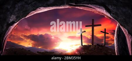 View Of Three Wooden Crosses And Sunrise From Open Tomb - Death And Resurrection Of Jesus Christ Stock Photo