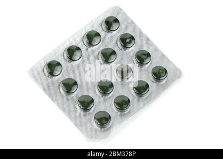 blister pack of green spirulina pills isolated on white background Stock Photo