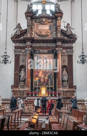 Feb 4, 2020 - Salzburg, Austria: Tourists admire the dome in front of altar inside Salzburg Cathedral Stock Photo