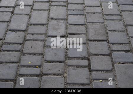 Brick pavement. Gray cobblestone pavement, background photo with perspective effect Stock Photo