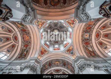 Feb 4, 2020 - Salzburg, Austria: Upward angle of central dome ceiling mural fresco and paintings inside Salzburg Cathedral Stock Photo