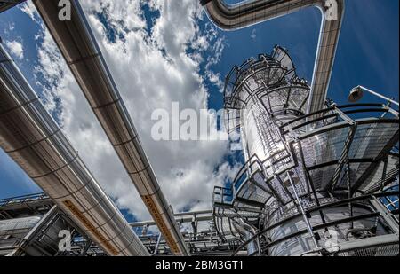 Natural gas processing plant structures with sun flare Stock Photo