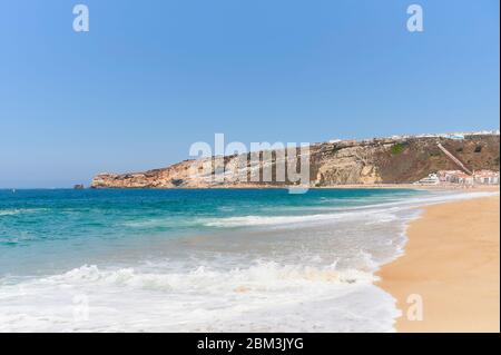 Summer morning at beach of Nazaré in Portugal Stock Photo