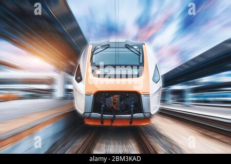 High speed train in motion on the railway station. Front view.