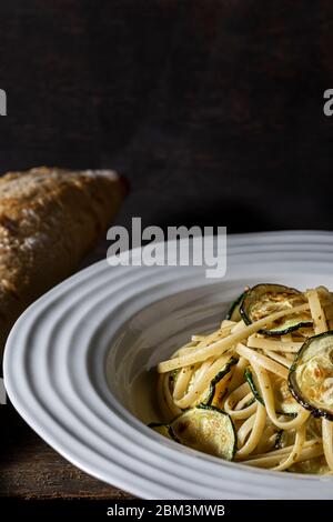 Vegan dish. Fettuccine pasta with oven roasted zucchini. Stock Photo