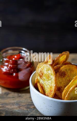 Home-made oven fried potato chips. Stock Photo