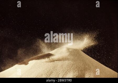 Freeze motion of dust particles on black background. Powder explosion. Abstract dust overlay texture.v Stock Photo