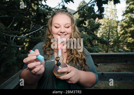 A young woman smokes cannabis Stock Photo