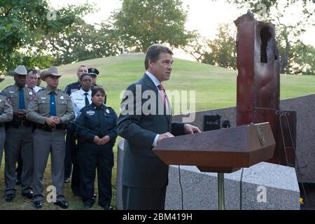 Austin Texas USA, September 11 2011: Texas Gov. Rick Perry commemorates the 10th anniversary of the September 11 terrorist attacks during a memorial ceremony at the Texas State Cemetery's Twin Towers Monument. Perry told the crowd that 'the images still linger in our minds and we will never forget the lives lost that day.'   ©Bob Daemmrich Stock Photo