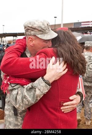 Fort Hood Texas USA, December 24, 2011: Army veteran greets loved one during welcome-home ceremony for troops returning on Christmas Eve from deployment in Iraq. ©Marjorie Kamys Cotera/Daemmrich Photography Stock Photo