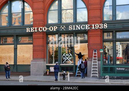 Workers boarding up the REI Flagship store in New York during the coronavirus COVID 19 crisis... SEE MORE INFO FOR FULL CAPTION Stock Photo