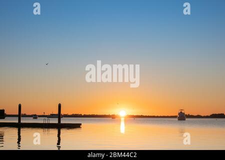 Sunrises over a calm and idyllic Tauranga harbour New Zealand. Stock Photo