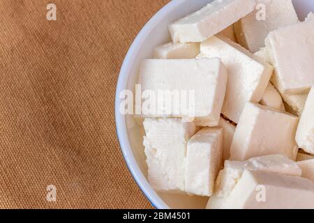 Paneer cottage cheese close up, slice pieces of homemade fresh white raw panner cheese. Stock Photo