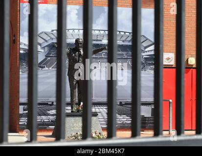 Liverpool, UK. 4th May, 2020. Anfield stadium during the suspension of the Premier League due to the Covid-19 virus pandemic; the statue of former manager Bill Shankly behind the padlocked gates of the Kop entrance Credit: Action Plus Sports/Alamy Live News Stock Photo