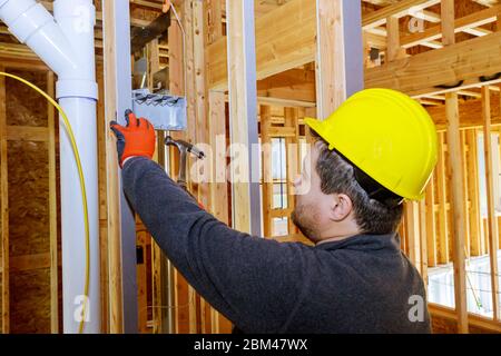 Hands of electrician installing electrical socket in new home Stock Photo