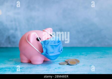 Pink piggy bank with medical mask Stock Photo