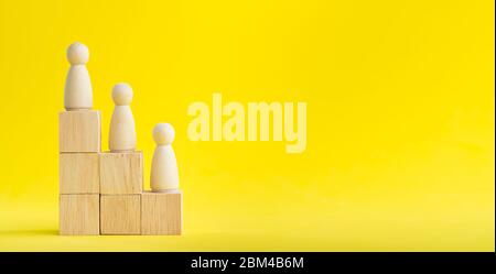 Banner Group of wood figure Standing in the hierarchy on wood stack in human resource management concepts Teamwork Success Leadership Business Progres Stock Photo