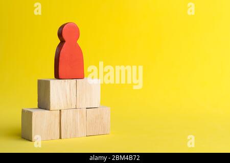 Red wood figure Stand on wood stack in human resource management or politics concepts, Teamwork Success Leadership Business Progress, Competition on y Stock Photo