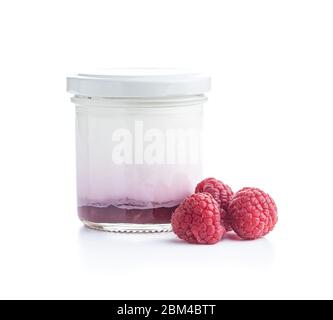 White fruity yogurt in jar an raspberries isolated on white background. Stock Photo