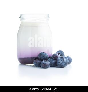 White fruity yogurt in jar and blueberries isolated on white background. Stock Photo