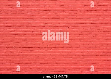 Old red painted brick wall texture background with thick frosting like appearance on its surface Stock Photo