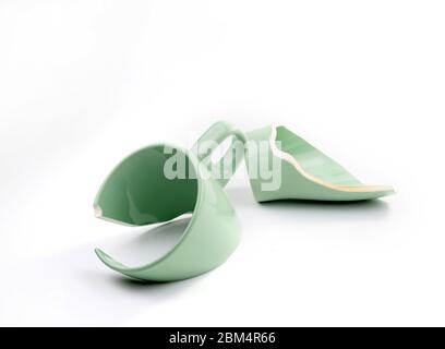 Broken coffee mug on white background, broken cup pieces, Broken relationship and Parting concept Stock Photo