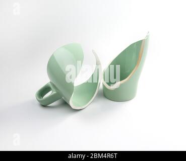 Broken coffee mug on white background, broken cup pieces, Broken relationship and Parting concept Stock Photo