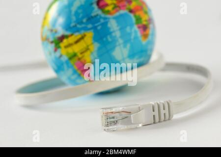 Internet cable with earth planet on white background - Concept of global internet connection Stock Photo