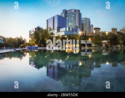 Odessa, Ukraine - April 03 2020: Modern night downtown in Odessa of Arcadia, with reflection on water surface. Concept: nightlife, relaxation in the m Stock Photo