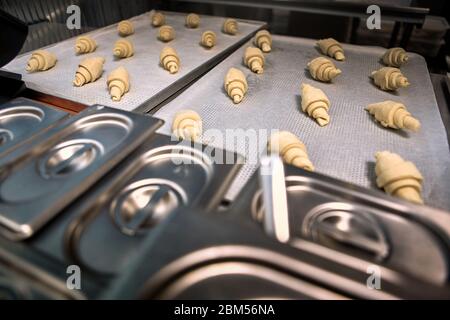 Small Business. Bakery shop production croissants on tray close-up Stock Photo