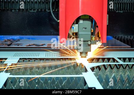 Close-up a laser cutting machine is working with a steel plate until it sparks on smart factory, industry 4.0 Stock Photo