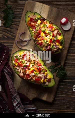 Avocado filled with tuna fish and vegetables Stock Photo