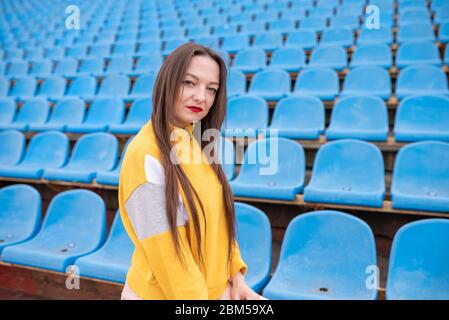 Girl alone in an empty stadium.  Stock Photo
